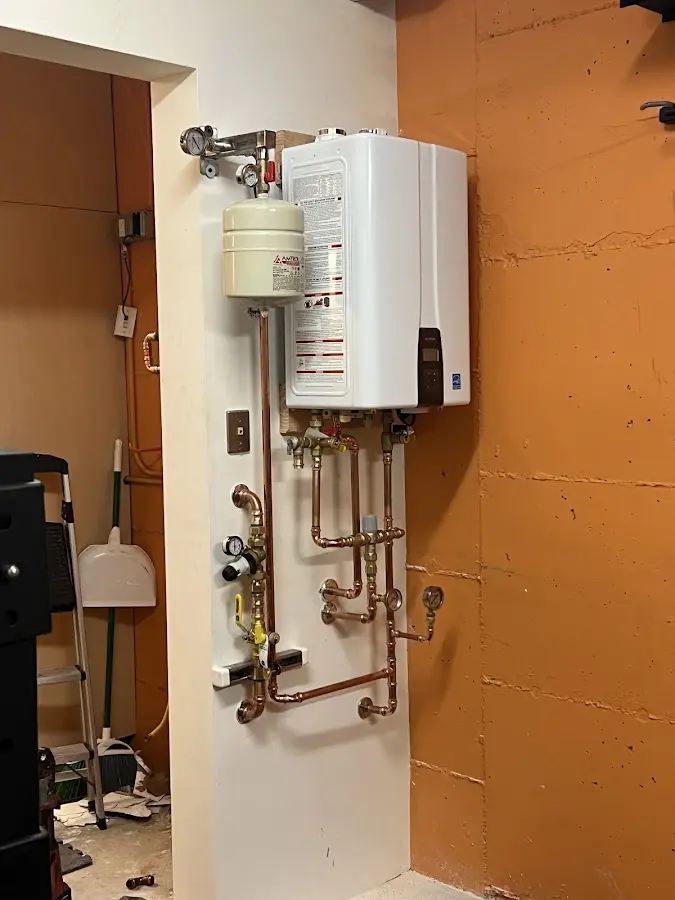 Plumbing technician inspecting water heater connections in Key Largo